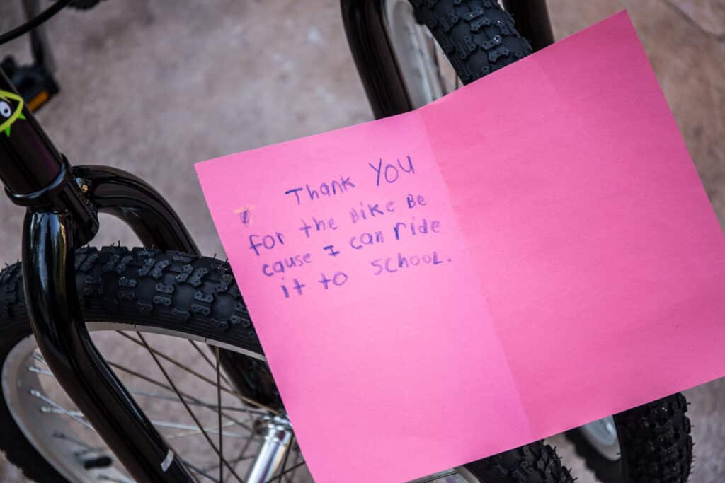 Corporate Social Responsibility (CSR) team-building activity bike building thank you card from deserving child who received a donated bike. Fire Power Seminars